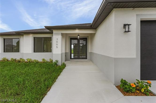 Oasis Model front entry — modern stucco home